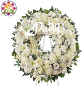 hermosa corona de condolencias de aproximadamente 100 cm de diámetro con rosas, pompos, margaritas, lirios blancos y flores de temporada y fino follaje verde