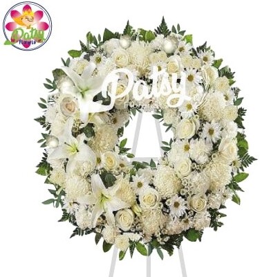 hermosa corona de condolencias de aproximadamente 100 cm de diámetro con rosas, pompos, margaritas, lirios blancos y flores de temporada y fino follaje verde